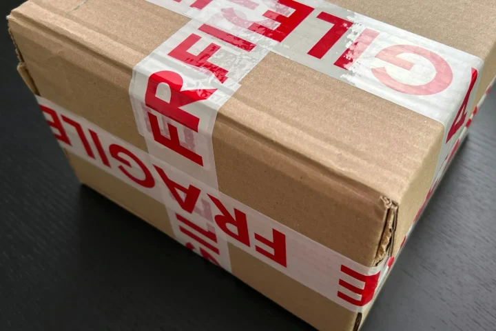 Cardboard delivery box sealed with fragile tape
