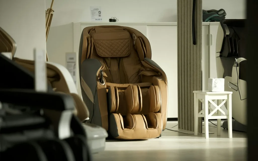 Brown leather full-body massage chair in a bright room