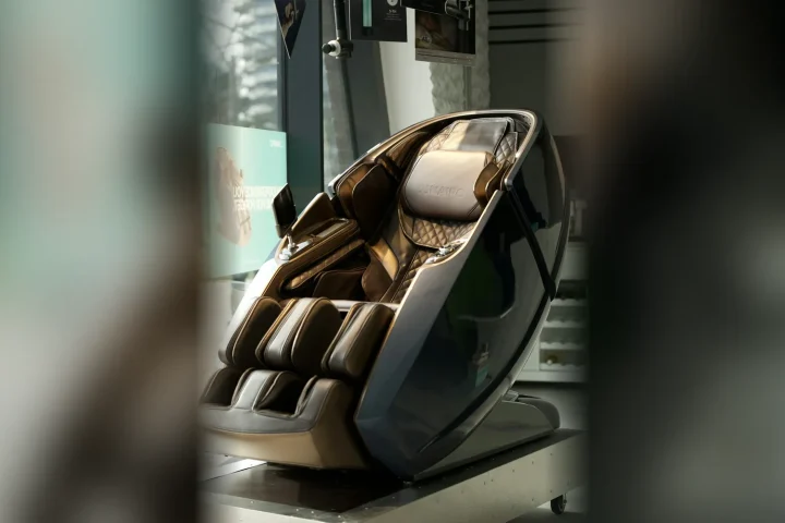 Dark brown massage chair with a curved modern frame